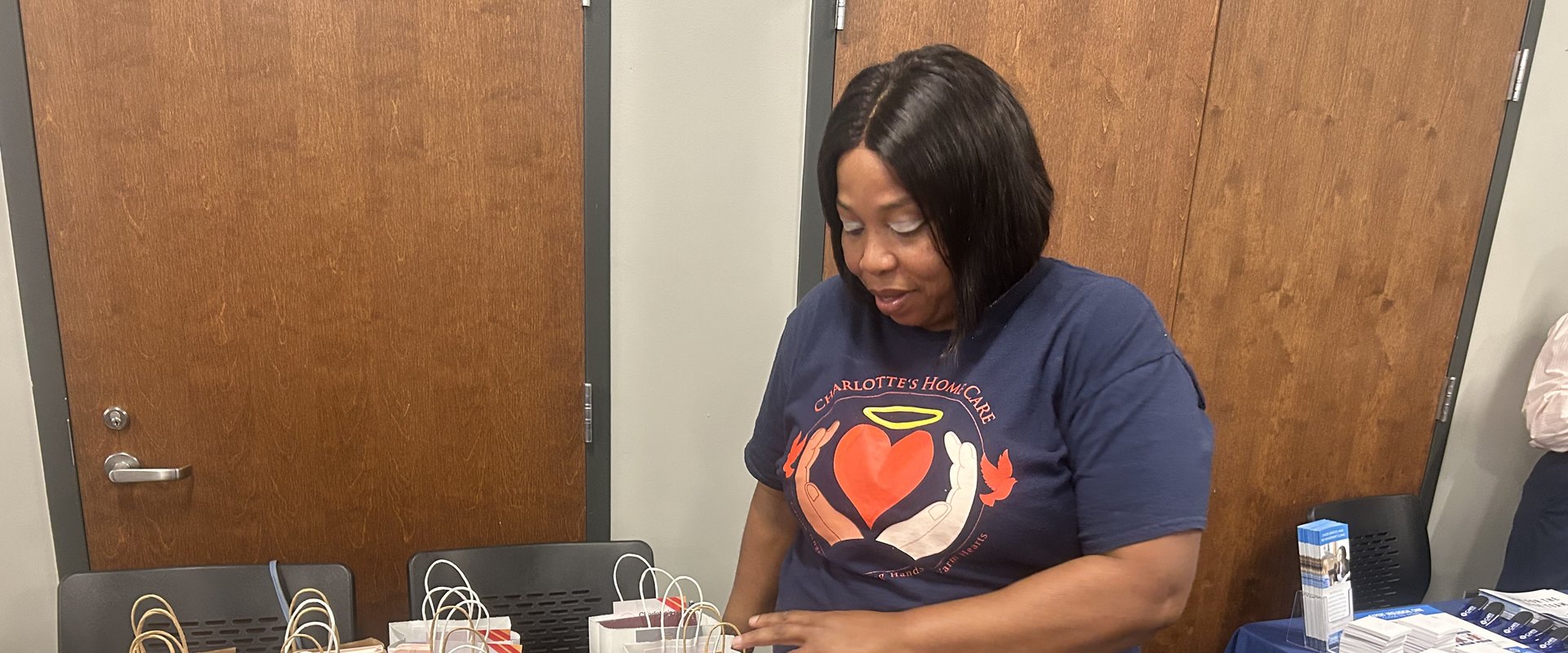 A Charlotte's Home Care team member at the agency's table at a community event