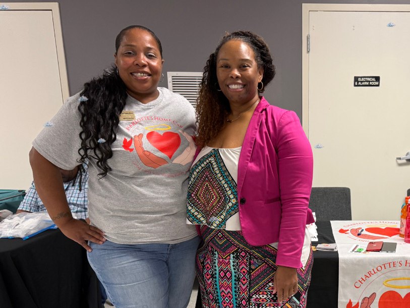 Two women at the Charlotte's Home Care table at a community resource event